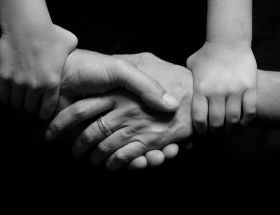 black and white connected hands love
