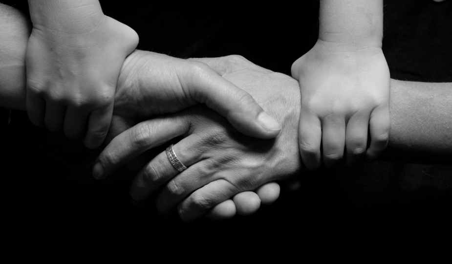 black and white connected hands love